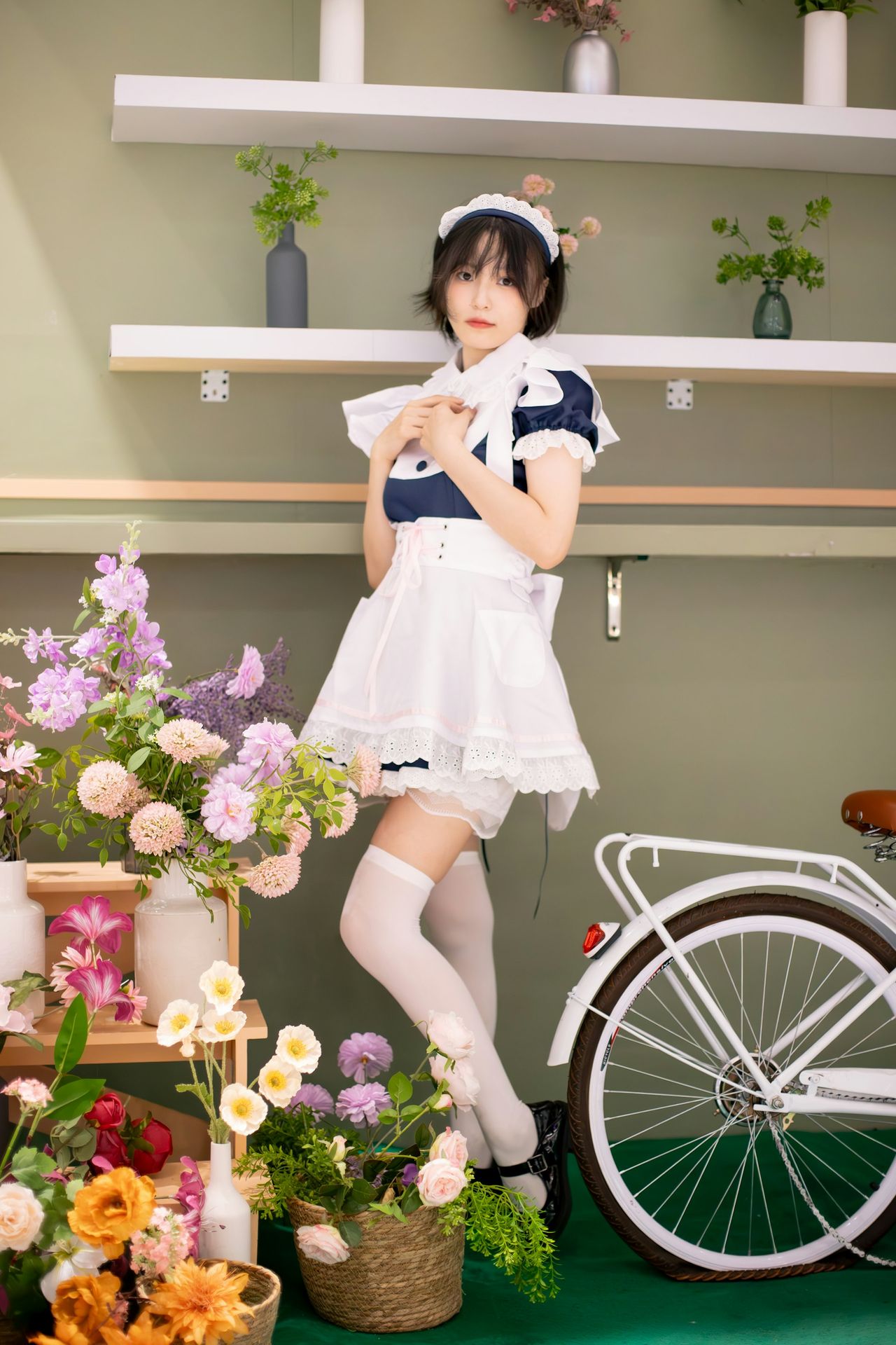 A woman poses in a maid outfit.